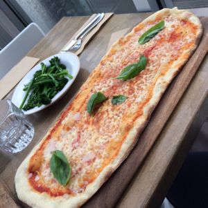 vegan pizza with a side of broccoli. at Zizzi - Cardiff Bay in Cardiff