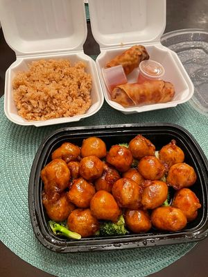 Orange chicken with side of fried rice and egg rolls at Veggie Express in Frisco