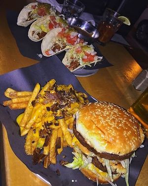 Bic Mac burger, bacon and cheese fries, and the bbq pork tacos at Bar Vegandale in Toronto