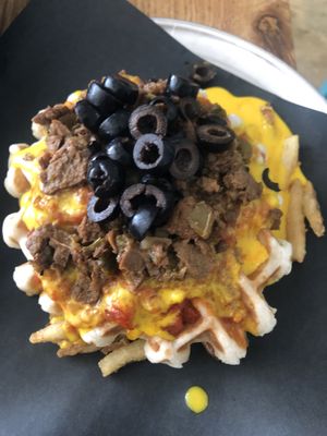 Messy pizza waffle at Bar Vegandale in Toronto