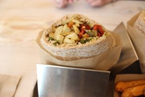 Fennel pita: roasted fennel, crispy potato, red pepper, pistachio pesto at Shouk in Washington