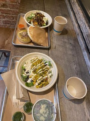 Shawarma bowl (top) with hummus, za'atar cauliflower (bottom) with kale salad at Shouk in Washington