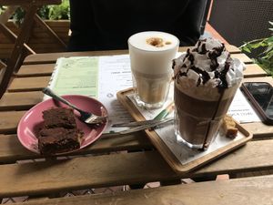 Vegan hot chocolate + whipped ‘cream’ with a piece of vegan chocolate cake at The Happiness Cafe  in Eindhoven