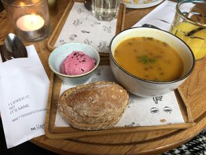 Pumpkin soup with lentils and some hummus and bread on the side  at The Happiness Cafe  in Eindhoven