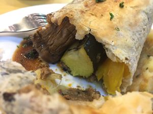 Baked filo pastry in Wellington style with carrot and potato mash, vegan truffle gravy at Veggle Cafe in Kowloon