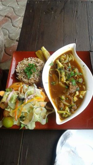Mock 'steak' (house made seitan) and broccoli in a ginger housin sauce served with lentil brown rice and fried plantains (vegan) at Kind Earth Eatery in Dar Es Salaam
