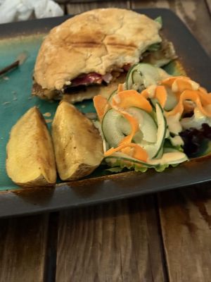 Partially eaten burger with potato wedges.    at Kind Earth Eatery in Dar Es Salaam