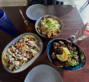 Loaded potatoes, guacamole tostadas, and Szechuan Brussels sprouts  at Graze in Nashville