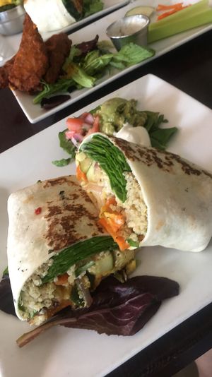 Root veggie burrito and seitan buffalo wings in the background!!! 10/10!!! at Graze in Nashville