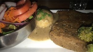 Seitan fillet with broccoli, mashed potatoes and gravy, and a side salad  at Graze in Nashville