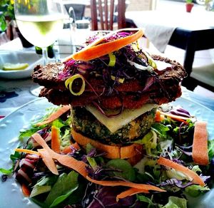 Vegan burger with beetroot and lentils, with rice cheese, obergin, salad and chips at Dolmen Bar in Lanzarote