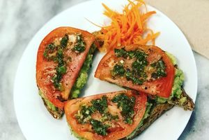 avocado toast  (avocado spread, slice tomato, chimichurri sauce on top of organic wheatberry bread at SpaJuiceBar in Fort Lauderdale