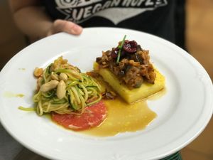 ";Morcilla"; de Berenjena sobre polenta con spagetis de calabacín con cacahuetes y caramelo de paraguaya  at 269 Gastro Vegan in Salamanca