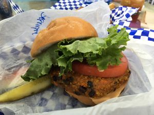 pretender on gluten free bun, pickle, and little slice of watermelon  at Beach Burgerz in Flagler Beach