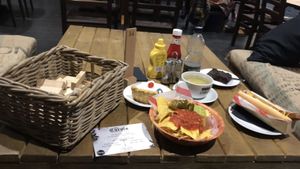 our spread of vegan yummies: nachos, hot dog, Bakewell tart and brownie, with a basket of jenga at 3 Three's Coffee Lounge in Birmingham