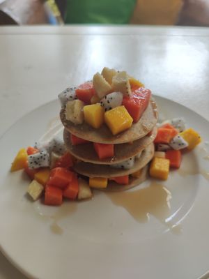 Vegan banana pancakes with tropical fruits and coconut caramel at Greenlight Cafe & Bar in Koh Samui