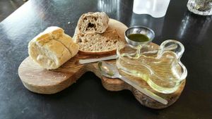 The wonderful assortment of breads I was served before my main course. The server who brought it to me initially served the bread with a dish of butter, but the one who had taken my main course order quickly realised this, came to my table and asked if I was vegan. When I confirmed, he graciously took away the butter and returned with accompaniments that were, in my opinion, far better than any non-dairy butter: olive oil, salt and fresh, local herbs. Yum! at Aalto Bistro in Reykjavik