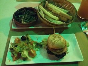Mushrooms served with toasted bread and a mini burger with salad. at Green Iguana Bar in Malaga