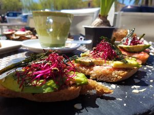 Avocado toasties with germinated seeds, nuts, algae, tomato and organic olive oil on home-made brown bread at Me Gusta in Mallorca