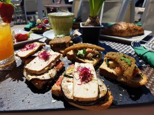 Vegan "pamboli" (typical Mayorcan) with smoked organic tofu, organic seitan snitzels, germinated seeds, avocado and grilled veggies at Me Gusta in Mallorca