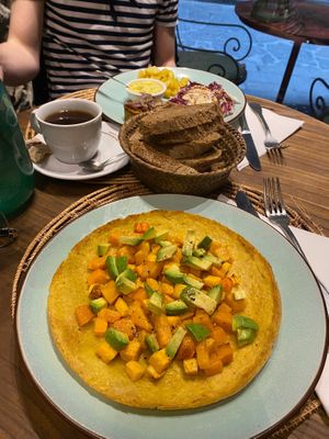 A chickpea pancake with roasted veg and avocado (closest) and a deconstructed vegan burger (further away)  at Carduccio in Florence