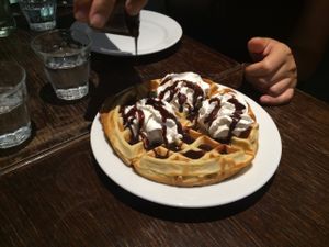 Waffle with chocolate sauce and whipped cream at Janine Loves Sunday in Paris