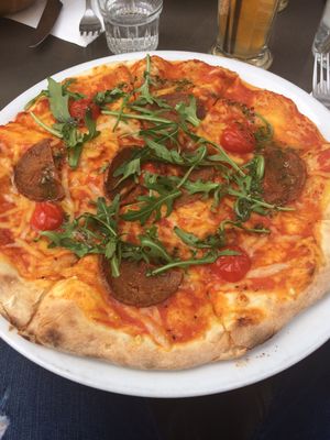 Chorizo pizza with “chorizo,” cherry tomatoes, basil, and pesto! Best pizza I’ve ever had. House-made cheese.  at Janine Loves Sunday in Paris