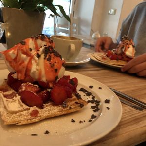 waffles with strawberries, ice cream and whipped cream (all vegan)  at Cafe Neue Liebe in Berlin