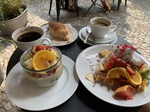 Breakfast feast: vegan waffle with fruit salad topped with light homemade whipped cream, oat bowl with lots of fresh and dried fruits, and last but not least, vegan croissant! at Cafe Neue Liebe in Berlin