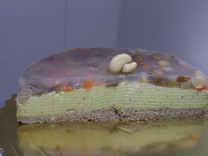 Savory pie with rice and pre-sprouted buckwheat , almonds , cashew mousse , zucchini and nutmeg , with a final agar agar jelly and seasonal vegetables . at Bio & Chocolate in Siena