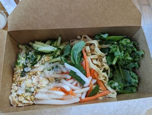 Salads are nicely boxed for transport with dressing on the side at Chau VeggiExpress - Granville Island Stall in Vancouver
