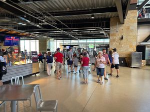 Behind section 101 and 142 behind yellow structure on field next to the Toyota tent it’s tucked away back there by the window  at Visiting Vegan in Arlington