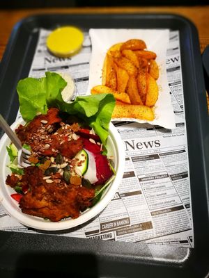 sides: fries and salad with faux-meat ontop  at Farma Burgerownia Roslinna in Krakow