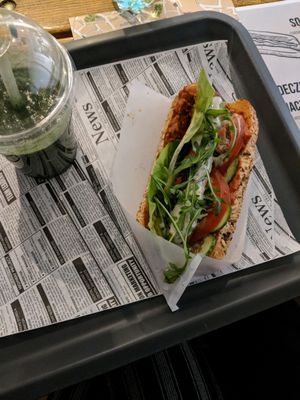 soy dog with chilli and garlic sauce and a green juice  at Farma Burgerownia Roslinna in Krakow