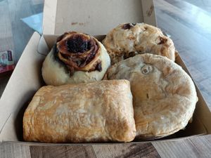 Clockwise from top Steak & Pepper pie, Chickn Pie, Sausage Roll, Cheesymite Scroll. at Veganyumm Bakehouse in Brisbane