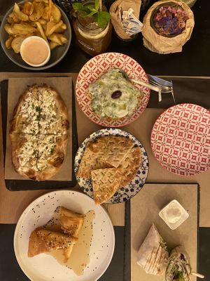 Crunchy potatoes with chunky mayo, Tsatsiki with Pita. Garlic Feta Flatbread, Feta in phyllo pastry, some wrap (I think this one was vegetarian, one of my boyfriends food)  at ONO by Marouli in Rhodes