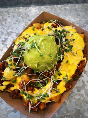 Brunch special: crispy potatoes rancheras with shiitake chorizo, cheesy sauce, and guacamole at Soul Cocina in Durham
