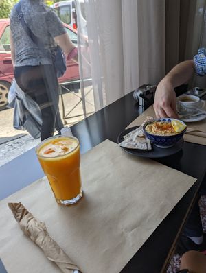 Fresh squeezed orange juice, hummus with rice pita chips, and Americano coffee at Veganaki in Athens
