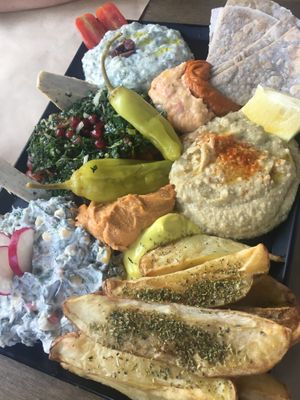 Sharing apetizer plate  at Veganaki in Athens