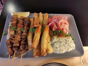 Souvlaki with baked potatoes, tzatziki and tomato salad at Veganaki in Athens