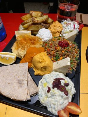 Appetizer platter with loads of sauces, lentils salad, veg Feta cheese, Pita, and hummus (it was huge, basically a full course!) at Veganaki in Athens
