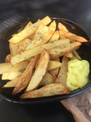 Oven baked chips with mustard mayo at Veganaki in Athens