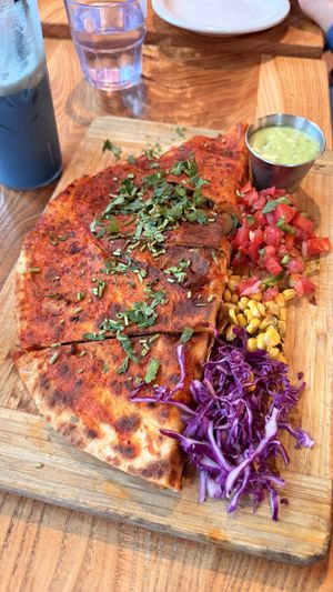 Quesadilla Grande dipped in Guajillo sauce  at Panaderia Nuevo Leon in Chicago