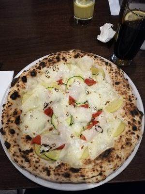 Pizza with potatos, bell peppers, zucchini and vegan cheese at La Stella Nera in Berlin