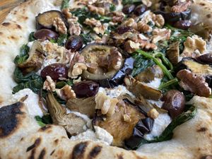 Spinach pizza with extra toppings   at La Stella Nera in Berlin