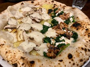 half white pizza with mushroom & smoked tofu; half white pizza with spinach, ricotta and walnuts at La Stella Nera in Berlin