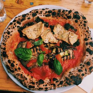 half and half cheeseless pizza, one side grilled veggies and the other chilli tofu   at La Stella Nera in Berlin