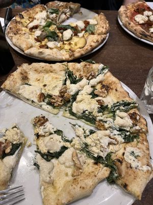 Spinach and walnut pizza (front), Artichoke (back) and diavola (right), all tasted very good. The diavola was actually not THAT spicy.  at La Stella Nera in Berlin