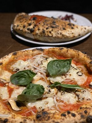 Salami pizza with mushrooms and onion; salami calzone  at La Stella Nera in Berlin