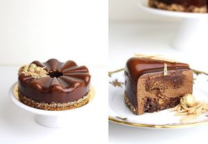 Vegan French cake. Dark chocolate 80% based brownie , hazelnut praline, milk chocolate mousse, chocolate glaçage.
Decorations: Grated caramel with white chocolate, hazelnuts in gold.  at Physalis in Warsaw